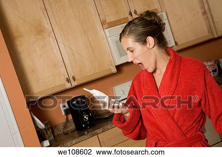 Woman in early 20s standing in the kitchen arguing on the telephone View Large Photo Image Stock Image - Woman in early 20s standing in the kitchen arguing on the telephone. Fotosearch