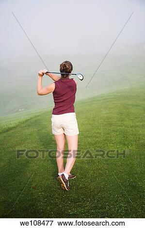 Woman in her mid 20s playing golf View Large Photo Image Stock Photo - Woman in her mid 20s playing golf. Fotosearch