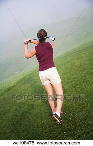 Woman in her mid 20s playing golf View Large Photo Image Stock Photo - Woman in her mid 20s playing golf. Fotosearch