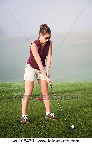 Woman in her mid 20s playing golf View Large Photo Image Stock Photo - Woman in her mid 20s playing golf. Fotosearch