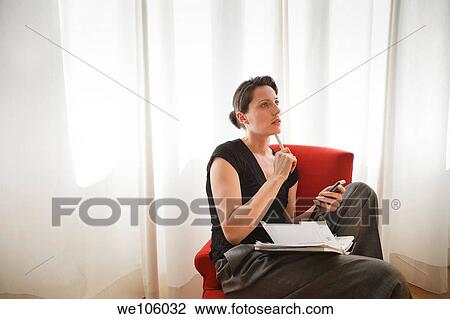 Stock Image - Woman working at home. Fotosearch