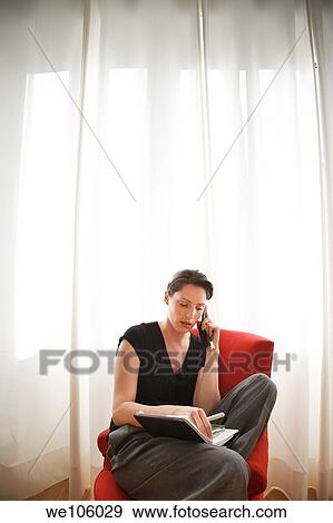 Stock Photo - Woman working at home. Fotosearch
