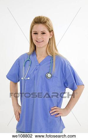 Stock Image - Young caucasian female nurse wearing scrubs outfit. Fotosearch
