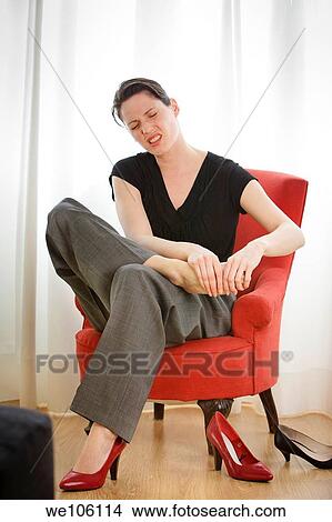 Picture - Young woman choicing shoes. Fotosearch