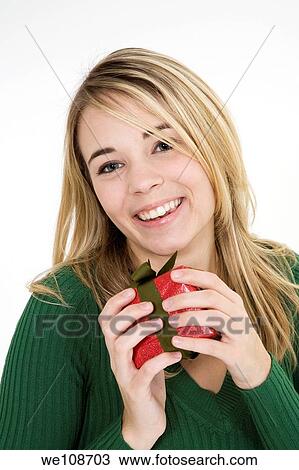 Young woman excited after recieving a special gift View Large Photo Image Stock Image - Young woman excited after recieving a special gift. Fotosearch