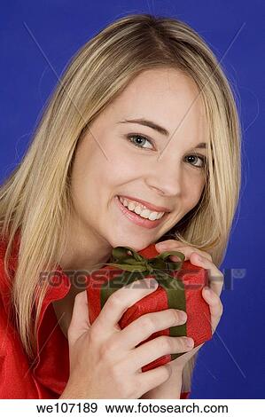 Young woman excited after recieving a special gift View Large Photo Image Stock Photo - Young woman excited after recieving a special gift. Fotosearch