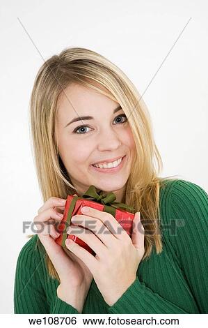 Young woman excited after recieving a special gift View Large Photo Image Stock Photograph - Young woman excited after recieving a special gift. Fotosearch