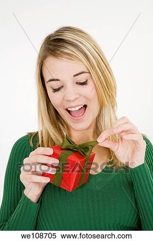 Young woman excited after recieving a special gift View Large Photo Image Stock Photography - Young woman excited after recieving a special gift. Fotosearch