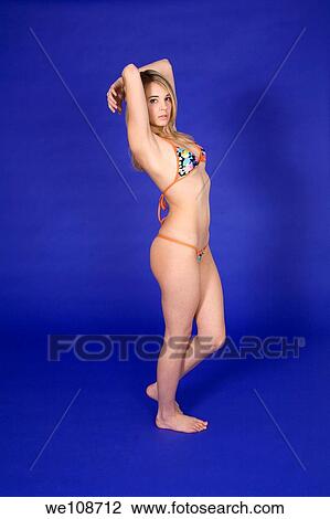 Young woman posing in a swim suit in a studio View Large Photo Image Stock Image - Young woman posing in a swim suit in a studio. Fotosearch