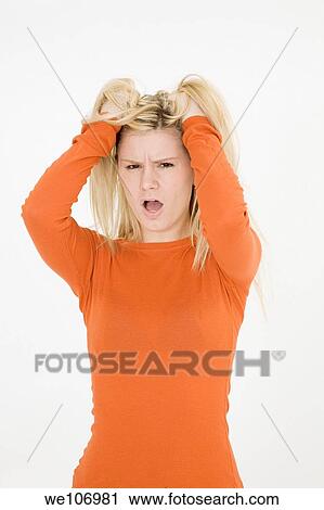 Young woman posing on white background looking very uoset View Large Photo Image Stock Image - Young woman posing on white background looking very uoset. Fotosearch
