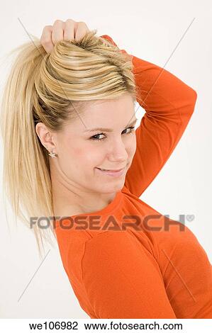 Young woman posing on white background with a smile View Large Photo Image Stock Image - Young woman posing on white background with a smile. Fotosearch