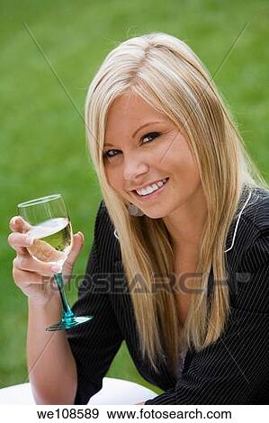 Young woman relaxing with a glass of wine in an outdoor cafe View Large Photo Image Stock Photo - Young woman relaxing with a glass of wine in an outdoor cafe. Fotosearch