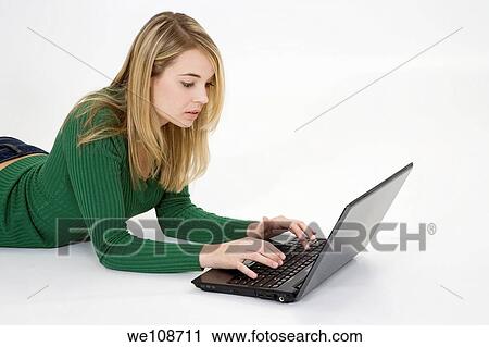 Young woman working on laptop computer on white background View Large Photo Image Stock Image - Young woman working on laptop computer on white background. Fotosearch