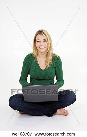 Young woman working on laptop computer on white background View Large Photo Image Stock Photo - Young woman working on laptop computer on white background. Fotosearch