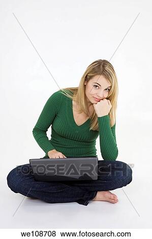 Young woman working on laptop computer on white background View Large Photo Image Stock Photo - Young woman working on laptop computer on white background. Fotosearch