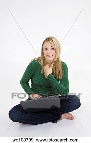 Young woman working on laptop computer on white background View Large Photo Image Stock Photo - Young woman working on laptop computer on white background. Fotosearch