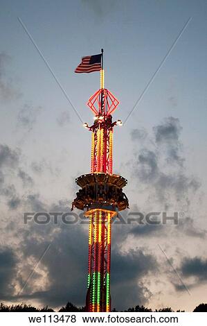 An American flag atop a lit carnival ride at a County Fair View Large Photo Image Stock Photo - An American flag atop a lit carnival ride at a County Fair. Fotosearch