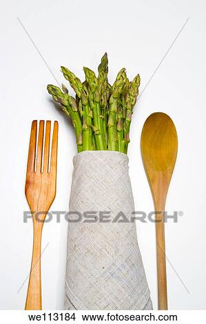 fresh wild asparagus on a table with cutlery View Large Photo Image Picture - fresh wild asparagus on a table with cutlery. Fotosearch