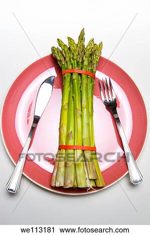 fresh wild asparagus on a table with cutlery View Large Photo Image Stock Image - fresh wild asparagus on a table with cutlery. Fotosearch