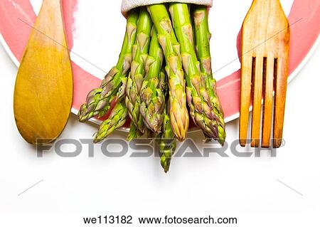 Stock Image - fresh wild asparagus on a table with cutlery. Fotosearch