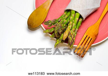 fresh wild asparagus on a table with cutlery View Large Photo Image Stock Image - fresh wild asparagus on a table with cutlery. Fotosearch
