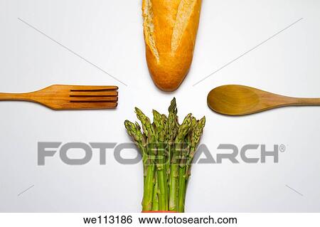 fresh wild asparagus on a table with cutlery and bread View Large Photo Image Stock Photograph - fresh wild asparagus on a table with cutlery and bread. Fotosearch