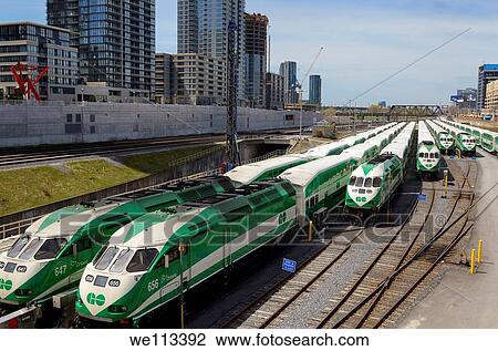 GO Train commuter railroad cars lined up on downtown Toronto tracks waiting for rush hour View Large Photo Image Stock Image - GO Train commuter railroad cars lined up on downtown Toronto tracks waiting for rush hour. Fotosearch