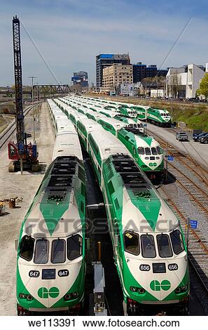 Stock Image - GO Transit commuter train cars lined up on downtown Toronto tracks waiting for rush hour. Fotosearch