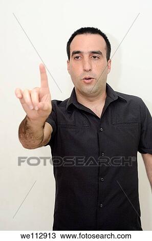 Listen to me, A young man in his thirties trying to make a point View Large Photo Image Stock Image - Listen to me, A young man in his thirties trying to make a point. Fotosearch