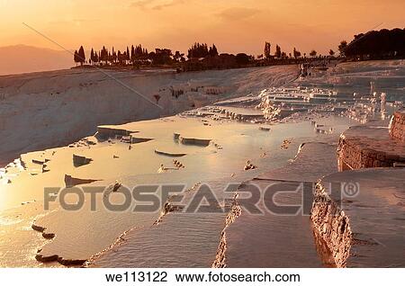 Pamukkale Travetine Terrace, Turkey, at sunset Images of the white Calcium carbonate rock formations View Large Photo Image Stock Image - Pamukkale Travetine Terrace, Turkey, at sunset Images of the white Calcium carbonate rock formations. Fotosearch