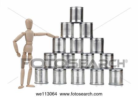 Wooden mannequin by a tin can pyramid, on white background, studio shot View Large Photo Image Picture - Wooden mannequin by a tin can pyramid, on white background, studio shot. Fotosearch