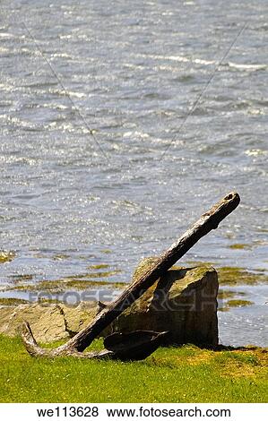 A rusted anchor left lying against a rock at Achill Sound, Achill, Co. Mayo, Ireland. View Large Photo Image Stock Photo - A rusted anchor left lying against a rock at Achill Sound, Achill, Co. Mayo, Ireland.. Fotosearch