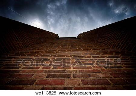 Brick wall leading to dramatically looking dark sky View Large Photo Image Stock Photography - Brick wall leading to dramatically looking dark sky. Fotosearch