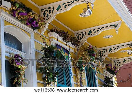 Closeup of decorative corbels with windows decorated for Mardi Gras on a Creole townhouse in the French Quarter of New Orleans, Louisiana View Large Photo Image Stock Photo - Closeup of decorative corbels with windows decorated for Mardi Gras on a Creole townhouse in the French Quarter of New Orleans, Louisiana. Fotosearch