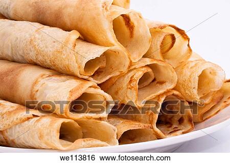 Detail of rolled crepes on white background View Large Photo Image Stock Photograph - Detail of rolled crepes on white background. Fotosearch
