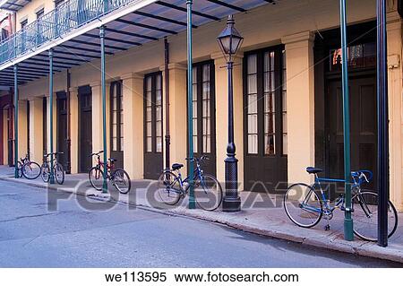 Stock Photography - Five bicycles attached to poles on attractive building on Chartres Street in French Quarter of New Orleans. Fotosearch