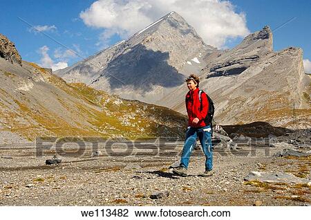 Hiker on the Laemmerboden plateau near the Gemmipass, behind Mt Rinderhorn and Mt Plattenhoerner, Leukerbad, Wallis, Switzerland View Large Photo Image Stock Image - Hiker on the Laemmerboden plateau near the Gemmipass, behind Mt Rinderhorn and Mt Plattenhoerner, Leukerbad, Wallis, Switzerland. Fotosearch