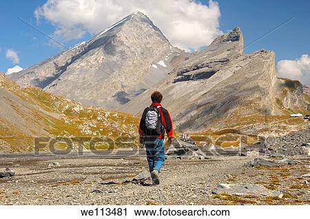 Hiker on the Laemmerboden plateau on the way to the Gemmi Pass, behind Mt Rinderhorn and Mt Plattenhoerner, Leukerbad, Wallis, Switzerland View Large Photo Image Stock Image - Hiker on the Laemmerboden plateau on the way to the Gemmi Pass, behind Mt Rinderhorn and Mt Plattenhoerner, Leukerbad, Wallis, Switzerland. Fotosearch