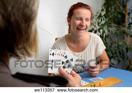 Laughing daughter playing Cribbage card game with mother at home View Large Photo Image Stock Photo - Laughing daughter playing Cribbage card game with mother at home. Fotosearch