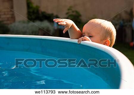 Photo of toddler exploring swimming pool in the garden View Large Photo Image Stock Image - Photo of toddler exploring swimming pool in the garden. Fotosearch