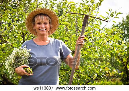 Portrait of happy mature woman in the garden View Large Photo Image Stock Photo - Portrait of happy mature woman in the garden. Fotosearch