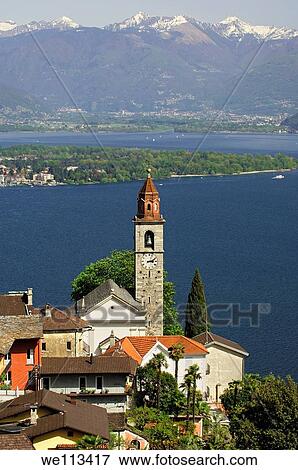 Ronco sopra Ascona at the lake Lago Maggiore, the Magadino Plain and the Lepontine Alps behind, Ticino, Switzerland View Large Photo Image Stock Photo - Ronco sopra Ascona at the lake Lago Maggiore, the Magadino Plain and the Lepontine Alps behind, Ticino, Switzerland. Fotosearch
