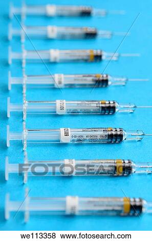Row of hypodermic syringes on a blue background View Large Photo Image Stock Photo - Row of hypodermic syringes on a blue background. Fotosearch