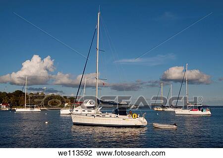 Sailboats moored in deep blue water in afternoon at Marina Cay in Tortola in British Virgin Islands View Large Photo Image Stock Image - Sailboats moored in deep blue water in afternoon at Marina Cay in Tortola in British Virgin Islands. Fotosearch