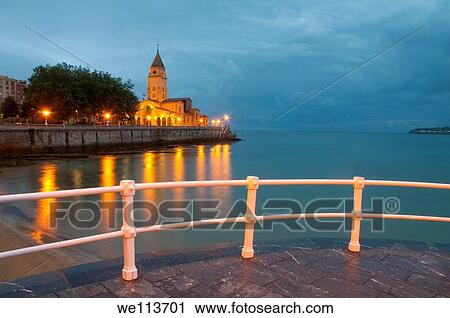 Stock Image - San Pedro church from the promenade, night view. Gijon, Asturias province, Spain.. Fotosearch