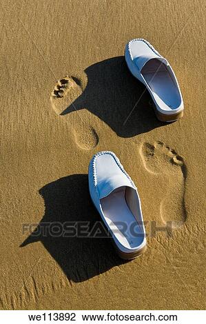 Shoes and footprints in the sand View Large Photo Image Stock Image - Shoes and footprints in the sand. Fotosearch