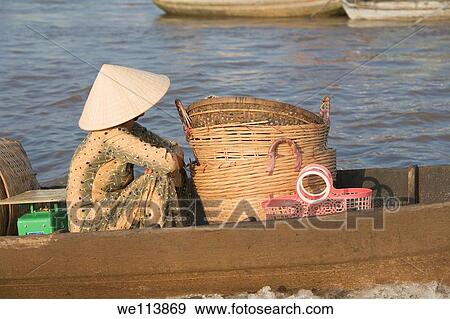 Stock Photo - Woman going to market in small boat, Cai Rang floating market, Mekong Delta, Ha Giang Province, Vietnam. Fotosearch