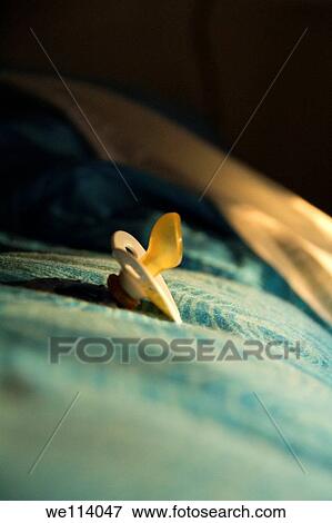 Baby´s pacifier on a bed View Large Photo Image Stock Photo - Baby´s pacifier on a bed. Fotosearch