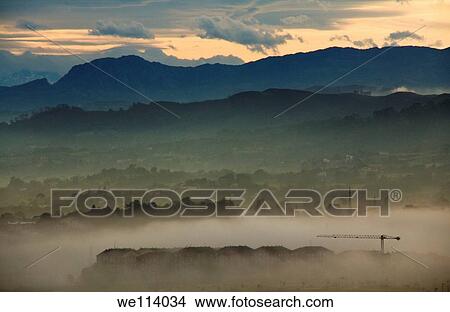 City covered with fog during sunrise View Large Photo Image Picture - City covered with fog during sunrise. Fotosearch