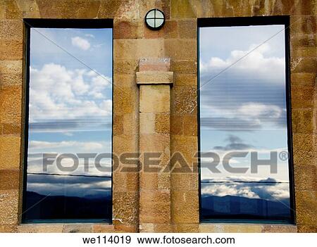 Stock Photo - Clouds reflected on the windows of a pre-romanesque building. Fotosearch